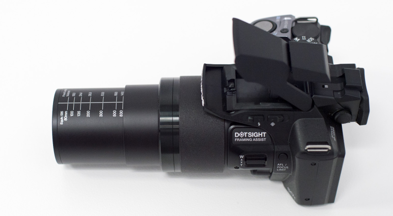Illustration for article titled OLYMPUS SP-100 Is a 50X Superzoom Camera With a Red Dot Sight Like a Gun